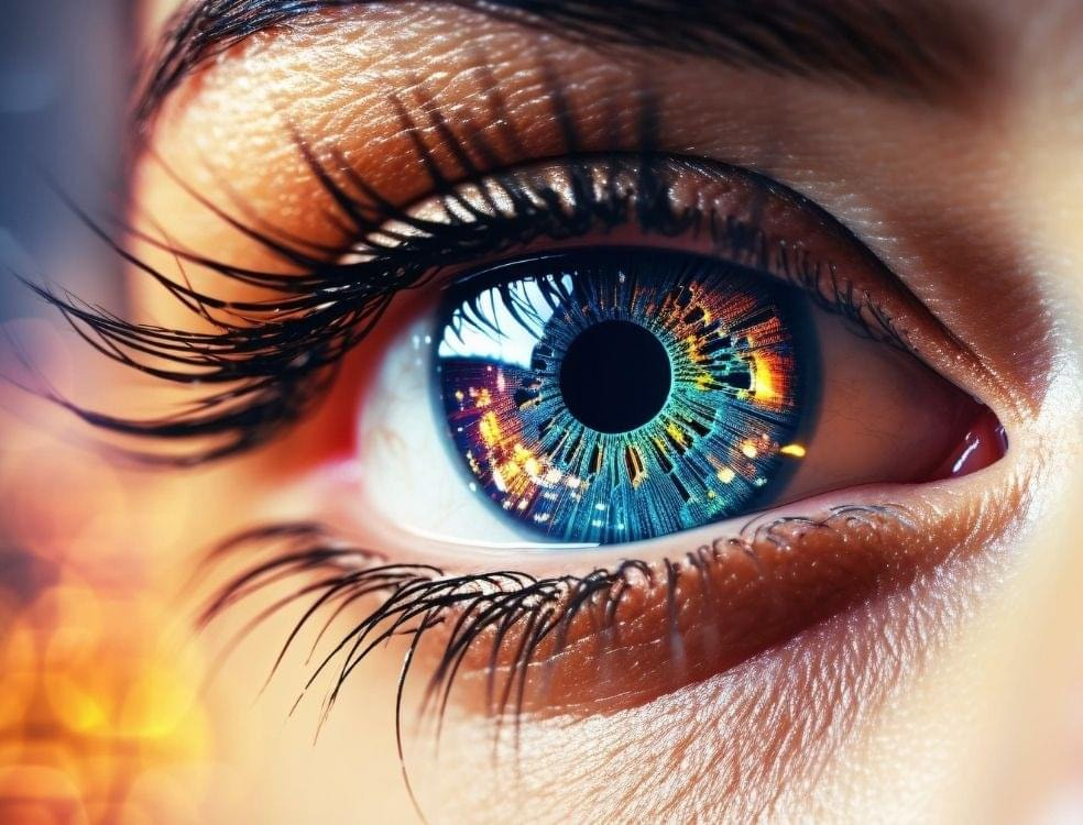 Close-up of a human eye with a glowing, cosmic iris